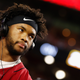 Arizona Cardinals quarterback Kyler Murray is seen standing against the lights of an NFL stadium.